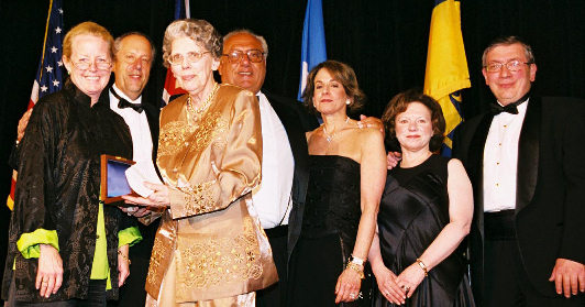 Barbara Mueller receiving Philatelic Achievement Award from Shelia Burke; from left to right, Shelia Burke, NPM Director Allen Kane, Barbara Mueller, Event Sponsors Mr. & Mrs. Arthur Morowitz and Mr. & Mrs. Harvey Bennett.